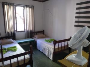 Un pat sau paturi într-o cameră la Pousada Joinville