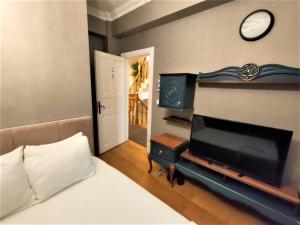 a bedroom with a bed and a clock on the wall at valide-maide hotel in Istanbul