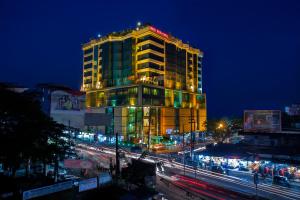 a tall building with lights on top of it at night at Rose View Hotel Sylhet in Sylhet