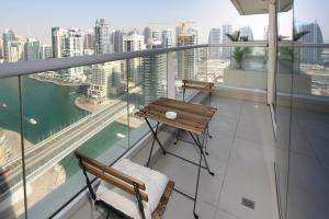 a balcony with two chairs and a view of the city at SHH - Luxury 1 BR with Balcony, Marina view, Continental Tower, Dubai Marina in Dubai