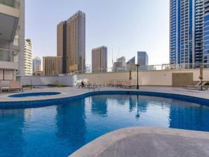 a large swimming pool on the roof of a building at SHH - Luxury 1 BR with Balcony, Marina view, Continental Tower, Dubai Marina in Dubai