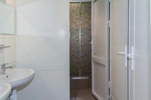 a white bathroom with a sink and a shower at AHOSTEL in Yekaterinburg