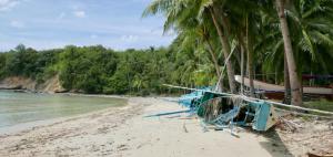 a beach with a bunch of chairs and palm trees at Acuario Beach Inn in San Vicente