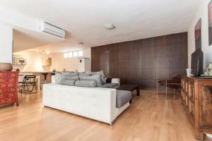 salon z białą kanapą i kuchnią w obiekcie LF PARKING INCLUIDO Amplio Loft en Barrio Santa Cruz w Sewilli