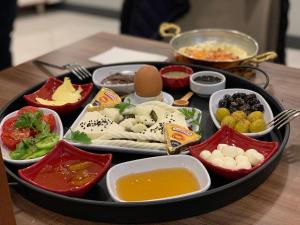 a tray full of food on a wooden table at Ooda Rooms Kadıköy in Istanbul