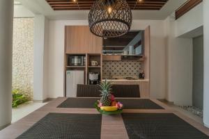 a room with a table with a pineapple and a bowl of fruit at Ola Villas at Uluwatu Pecatu in Uluwatu