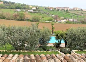 an aerial view of a garden with trees and a swimming pool at Villarondanella in Fermo