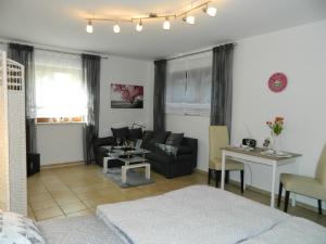 a living room with a couch and a table at Ferienwohnung Kiko in Zornheim