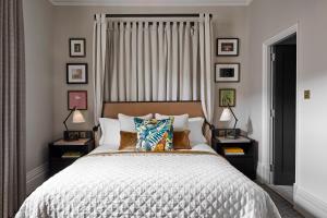 a bedroom with a large bed with two night stands at Kimpton Fitzroy London by IHG in London