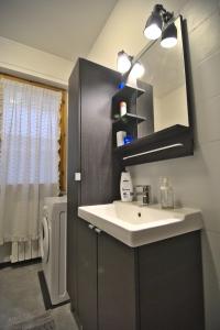 a bathroom with a sink and a mirror at Holiday House Torre del Lago in Torre del Lago Puccini