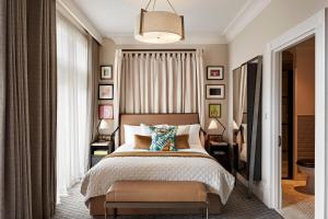 a bedroom with a bed and a large window at Kimpton - Fitzroy London, an IHG Hotel in London