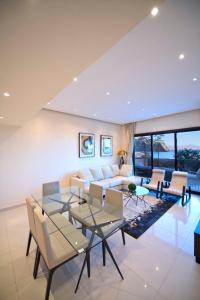 a living room with a couch and a table and chairs at Private 003 - Property Advisers in Dibba