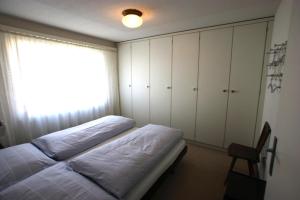 a bedroom with two beds and a window at Valbella in Davos