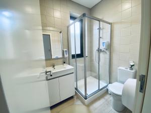 a bathroom with a shower and a toilet and a sink at Family Hostel Costa Nova in Costa Nova