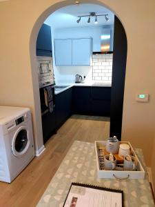 a kitchen with a washer and dryer next to a washer at 1 WATER PUMP HOUSE in Bury Saint Edmunds