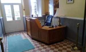 an office with a desk and a chair and a lamp at Tower Hotel in Talgarth