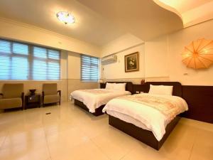 Postel nebo postele na pokoji v ubytování Ho Feng Private Hotel 電梯自助民宿