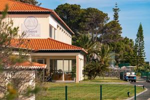 a house with a fence in front of it at Albatroz Beach & Yacht Club in Santa Cruz