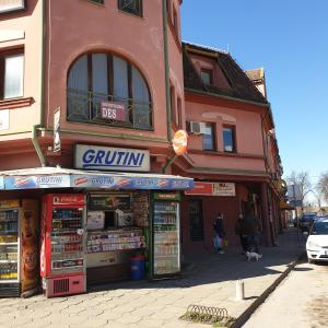 a group of shops on the side of a street at Blue apartman in Sombor
