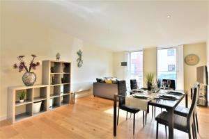 a dining room and living room with a table and chairs at Cardinals Apartment in Lincoln