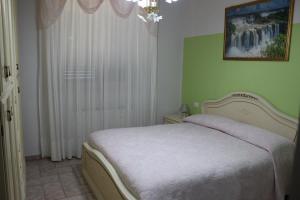 A bed or beds in a room at Villa Lucia B&B