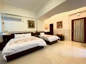 Postel nebo postele na pokoji v ubytování Ho Feng Private Hotel 電梯自助民宿
