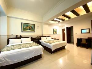 Postel nebo postele na pokoji v ubytování Ho Feng Private Hotel 電梯自助民宿