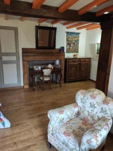 a living room with a couch and a desk at La Commanderie in Loison-sur-Créquoise