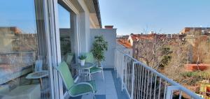 a balcony with a table and chairs and a view at Bellevue Apartment in Zagreb