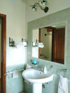 a bathroom with a white sink and a mirror at Villa Paladino Solunto in Santa Flavia