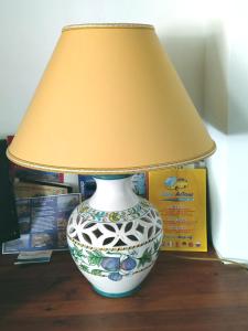 a vase with a lamp on top of a table at Villa Paladino Solunto in Santa Flavia