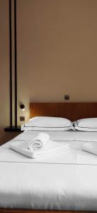 a large white bed with two pillows on it at Stories & So in Agios Nikolaos