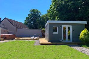a tiny house in a yard with a backyard at Highland HotTub Retreat, on NC500 in Inverness