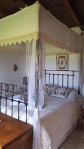 a bedroom with a bed with a canopy at HideAway Lasa in Lasa