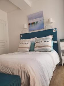 a bedroom with a blue and white bed with pillows at Appartement de charme citadelle Bastia in Bastia