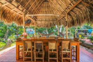 
a dining room with a table and chairs at Manigua Tayrona Hotel in El Zaino
