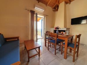 a kitchen and dining room with a table and chairs at Stoupa Lefktro 4 in Stoupa