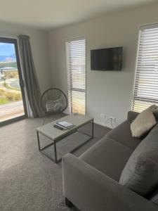 a living room with a couch and a table at Starview 88 Apartment in Lake Tekapo