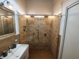 a bathroom with a shower with a sink and a mirror at Residenza la Mandorla in Perugia +29 photos