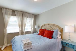 a bedroom with a bed with red pillows and a window at Library House in Durango