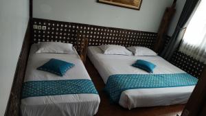 A bed or beds in a room at Kampung Sumber Alam Garut