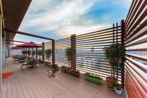 a balcony with tables and potted plants on a building at Holiday Inn Express Changzhou Lanling, an IHG Hotel in Changzhou