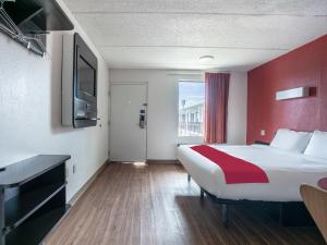 a hotel room with a large bed and a tv at OYO Hotel Lake Park/Valdosta I-75 in Lake Park