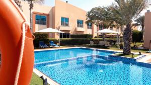 a swimming pool in front of a building at Coral Boutique Villas in Dubai