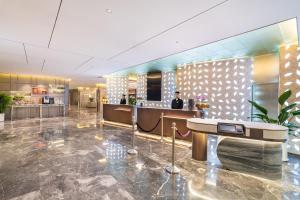 a lobby of a hotel with a reception desk at Novotel Xi'an The Bell Tower in Xi'an