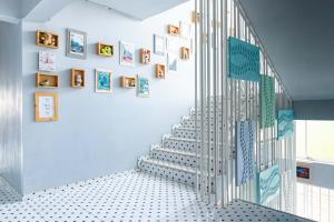 a staircase in a room with pictures on the wall at AA Resort Hotel in Pak Kret