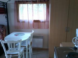 a kitchen with a table and chairs and a window at Chambres chez l'habitant Coco2 in Boulazac