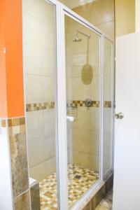 a shower with a glass door in a bathroom at Cresta Botsalo Hotel in Palatswe