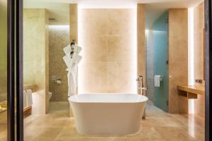 a bath tub in a bathroom with a shower at Hotel28 Myeongdong in Seoul
