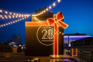 a sign that is lit up with lights at Hotel28 Myeongdong in Seoul